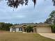 One-story house with stone accents and a two-car garage at 1060 Sw Big Tree Rd, Dunnellon, FL 34431