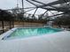 Screened-in pool with concrete decking at 1060 Sw Big Tree Rd, Dunnellon, FL 34431