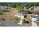 Aerial view of a single-story house with driveway, surrounded by other homes and trees at 10856 Sw 79Th Ave, Ocala, FL 34476