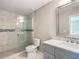 Modern bathroom with a walk-in shower, gray vanity, and a large mirror at 10856 Sw 79Th Ave, Ocala, FL 34476