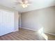 Well-lit bedroom featuring wood-look floors, ceiling fan and large closet at 10856 Sw 79Th Ave, Ocala, FL 34476