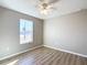 Well-lit bedroom with wood-look floors, ceiling fan, and a window at 10856 Sw 79Th Ave, Ocala, FL 34476