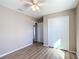 Bright bedroom with wood-look floors, ceiling fan, and closet at 10856 Sw 79Th Ave, Ocala, FL 34476