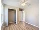 Bright bedroom with wood-look floors, ceiling fan and closet at 10856 Sw 79Th Ave, Ocala, FL 34476