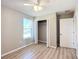 Spacious bedroom with wood-look floors, ceiling fan, and a large closet at 10856 Sw 79Th Ave, Ocala, FL 34476