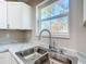 Double stainless steel sink with modern faucet in the kitchen at 10856 Sw 79Th Ave, Ocala, FL 34476