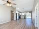 Open concept living room and kitchen with vinyl plank flooring and high ceilings at 10856 Sw 79Th Ave, Ocala, FL 34476