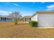 Side yard view showing a screened patio and well-maintained landscaping at 11518 Sw 136Th Pl, Dunnellon, FL 34432