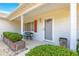 Covered front porch with seating and landscaping at 11518 Sw 136Th Pl, Dunnellon, FL 34432