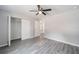 Well-lit bedroom with double door closet and wood-look floors at 117 Nw Sparrow Rd, Dunnellon, FL 34431