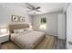 Main bedroom with plush bed, ceiling fan and wood-look floors at 117 Nw Sparrow Rd, Dunnellon, FL 34431