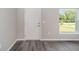 Bright entryway with a white door and large window, showcasing grey vinyl plank flooring at 117 Nw Sparrow Rd, Dunnellon, FL 34431