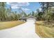 Newly constructed home with a gray exterior, white garage door, and concrete driveway at 117 Nw Sparrow Rd, Dunnellon, FL 34431