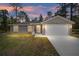 Newly built home with a two-car garage and a well-manicured lawn at 117 Nw Sparrow Rd, Dunnellon, FL 34431