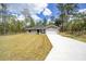 Newly built home featuring gray siding, a white garage door, and a spacious yard at 117 Nw Sparrow Rd, Dunnellon, FL 34431