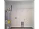 Laundry room with shelving, water heater, and built-in utility sink at 117 Nw Sparrow Rd, Dunnellon, FL 34431