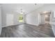 Spacious living room featuring grey vinyl plank flooring and a ceiling fan at 117 Nw Sparrow Rd, Dunnellon, FL 34431