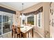 Bright dining area with a wooden table, bay window and hardwood floors at 12531 Se 90Th Ter, Summerfield, FL 34491