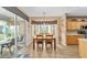 Kitchen dining area with wooden table and access to a screened porch at 12531 Se 90Th Ter, Summerfield, FL 34491