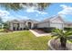 One-story house with gray siding, landscaping, and a two-car garage at 12531 Se 90Th Ter, Summerfield, FL 34491