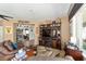 Cozy living room with leather furniture and built-in shelving at 12531 Se 90Th Ter, Summerfield, FL 34491