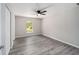 Bedroom with wood-look floors, ceiling fan, and closet at 1280 Nw Redwood Dr, Dunnellon, FL 34431