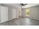 Bedroom with wood-look floors, ceiling fan, and an ensuite bathroom at 1280 Nw Redwood Dr, Dunnellon, FL 34431