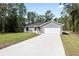 New construction home with a long driveway and mature trees at 1280 Nw Redwood Dr, Dunnellon, FL 34431