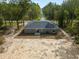 Rear view of a house with gray siding and a sliding glass door at 1280 Nw Redwood Dr, Dunnellon, FL 34431