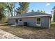 Rear view of house with gray siding and gray roof at 1280 Nw Redwood Dr, Dunnellon, FL 34431