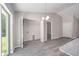 Bright laundry room with built-in shelving and vinyl flooring at 1280 Nw Redwood Dr, Dunnellon, FL 34431