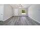 Open living room featuring gray vinyl flooring and a ceiling fan at 1280 Nw Redwood Dr, Dunnellon, FL 34431