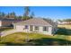 One-story house with a gray roof, light gray siding, and American flag at 13198 Sw 29Th Cir, Ocala, FL 34473