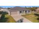 Aerial view of a house with a gray exterior and a two-car garage at 13198 Sw 29Th Cir, Ocala, FL 34473