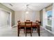 Bright dining room with wood table and chairs, hardwood floors, and a large window at 13198 Sw 29Th Cir, Ocala, FL 34473