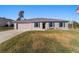 House with gray exterior, blue shutters, and a landscaped lawn at 13198 Sw 29Th Cir, Ocala, FL 34473