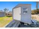 Gray storage shed with a wooden ramp and a small window at 13198 Sw 29Th Cir, Ocala, FL 34473