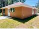 Exterior of the house displaying the sides and back, showcasing the newly installed windows and lawn at 13253 Se 35Th Ct, Belleview, FL 34420