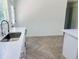Stylish kitchen with stainless steel sink, quartz countertops, and herringbone tile flooring at 13253 Se 35Th Ct, Belleview, FL 34420
