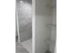 Adjacent walk-in shower with gray-toned tiling and open shelving offers convenience at 13253 Se 35Th Ct, Belleview, FL 34420