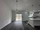 Dining area with sliding glass doors to the backyard and modern lighting at 13766 Sw 115Th Pl, Dunnellon, FL 34432