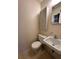 Small bathroom with toilet, sink, and built-in cabinet at 14419 Sw 43Rd Court Rd, Ocala, FL 34473