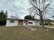 Brick and white ranch home with a carport and mature trees at 14419 Sw 43Rd Court Rd, Ocala, FL 34473