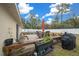 Deck with seating, umbrella, grill, and potted plants; overlooks a fenced backyard at 16867 Sw 40Th Cir, Ocala, FL 34473