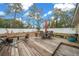 Large wooden deck with patio furniture and a hammock, perfect for outdoor relaxation at 16867 Sw 40Th Cir, Ocala, FL 34473