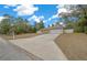 Single-story house with a white garage door and a long driveway at 16867 Sw 40Th Cir, Ocala, FL 34473