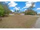 House with a large yard, white fence, and a driveway at 16867 Sw 40Th Cir, Ocala, FL 34473