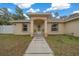 House entrance with a covered porch and walkway at 16867 Sw 40Th Cir, Ocala, FL 34473