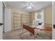 Bright home office with a large desk and shelving unit at 16867 Sw 40Th Cir, Ocala, FL 34473