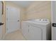 Laundry room with washer, dryer, and ample shelving at 16867 Sw 40Th Cir, Ocala, FL 34473